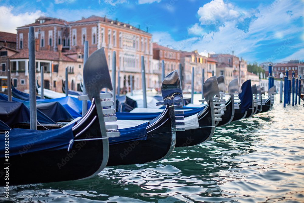 Gondolas moored at the pier in Grand Canal with the view of historical buildings at Venice, Italy. Vacation concept with the view of Venice.