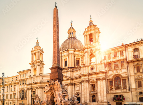 Navona Square in sunlight, Rome, Italy. Sant'Agnese church and Four Rivers fountain with Egyptian obelisk. Piazza Navona is famous tourist attraction of Rome. photo