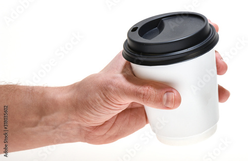 Hand holding coffee to go