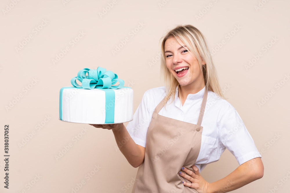 Young Russian woman with a big cake over isolated background Young Russian woman with a big cake over isolated background