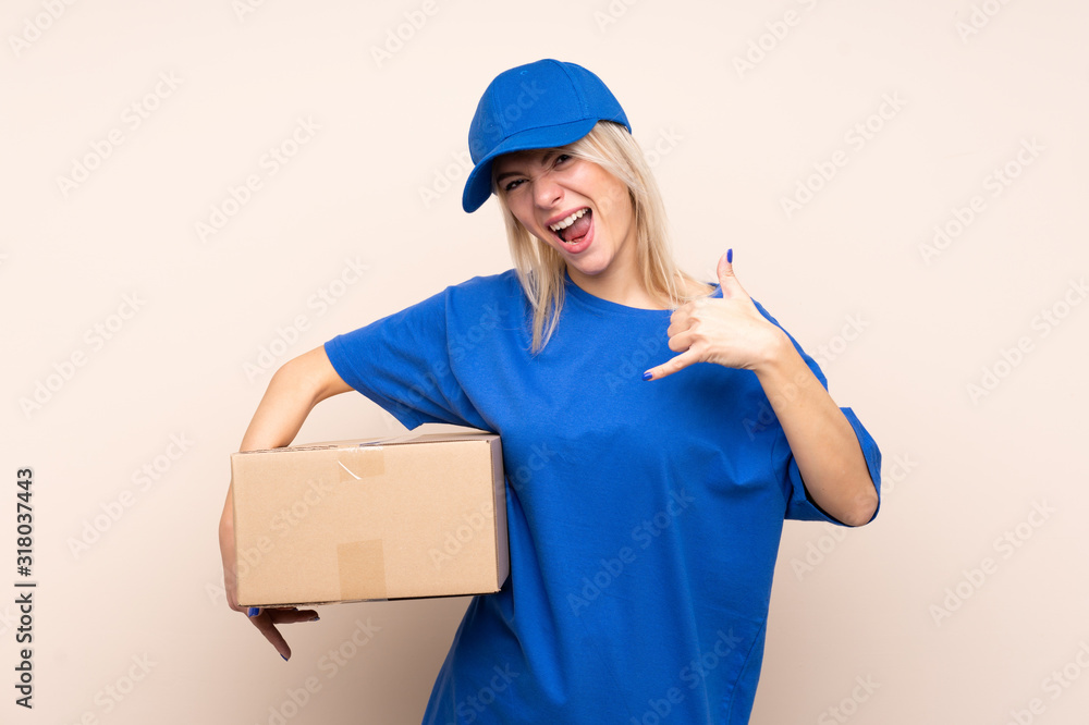 Young delivery woman over isolated background making phone gesture Young delivery woman over isolated background making phone gesture