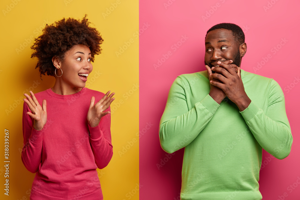 Φωτογραφία Surprised emotional Afro American woman tells funny story to boyfriend, raises p