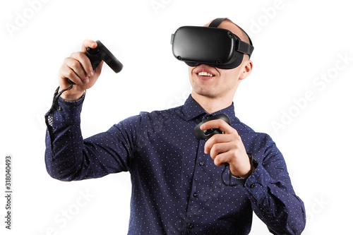 Young man wearing virtual reality glasses during a working break. Behind them is a pure white background.