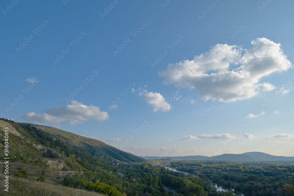 Hillside with blue sky and clouds