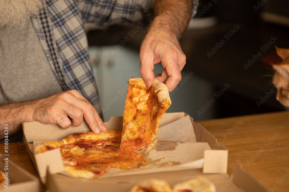 Hot pizza slice with melting cheese. Lunch or dinner delicious food italian traditional on wooden table in side view. Selective focus.