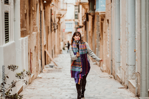 .Young female tourist touring Valletta, capital of Malta. Travelling with a compact camera to broadcast her trip on social networks. Lifestyle © lubero