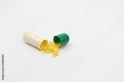 open capsule on white background