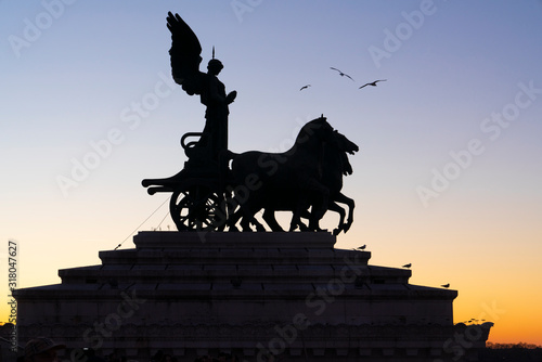 Statue during sunset at altare della patria (Altar of the fatherland - Vitor Emanuel II National monument)