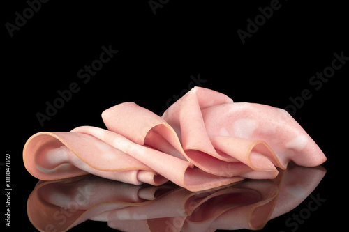 Slices of sausage iatlian mortadella with reflection isolated on the black background, close up, side view photo