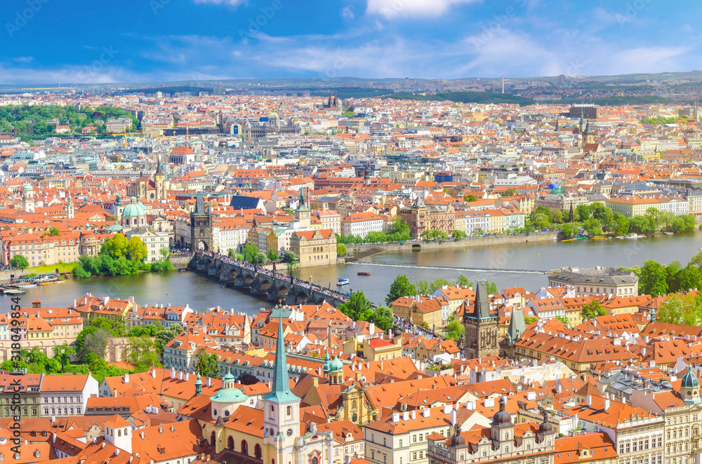 Top aerial panoramic view of Prague historical city centre with red tiled roof buildings in Mala Strana Lesser Town and Old Town, Charles Bridge Karluv Most over Vltava river, Bohemia, Czech Republic