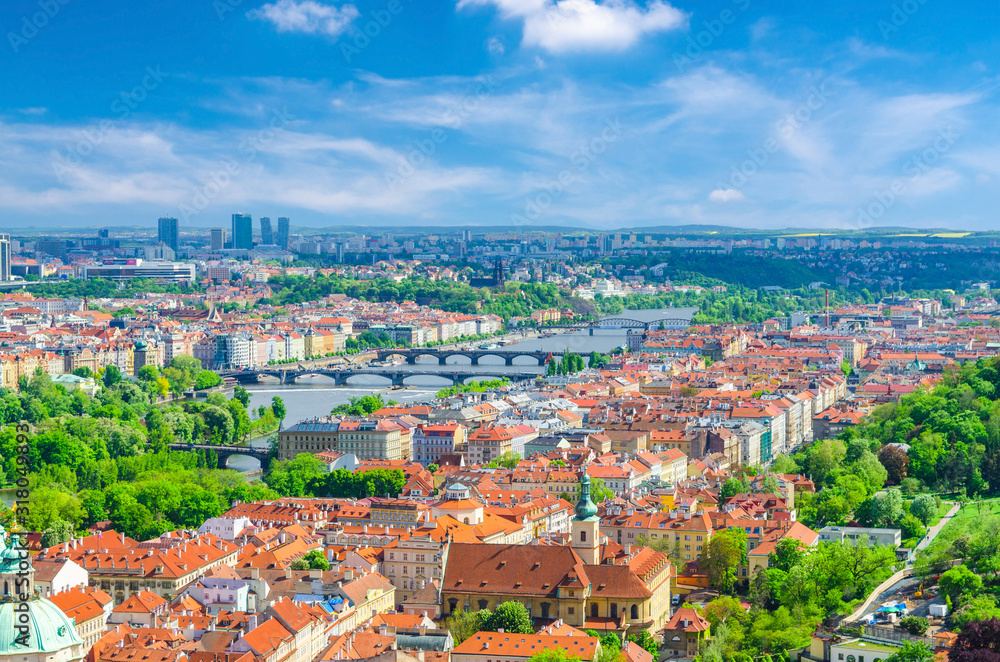 Top aerial panoramic view of Prague historical city centre with red tiled roof buildings in Mala Strana Lesser Town and Smichov districts, bridges over Vltava river, Bohemia, Czech Republic