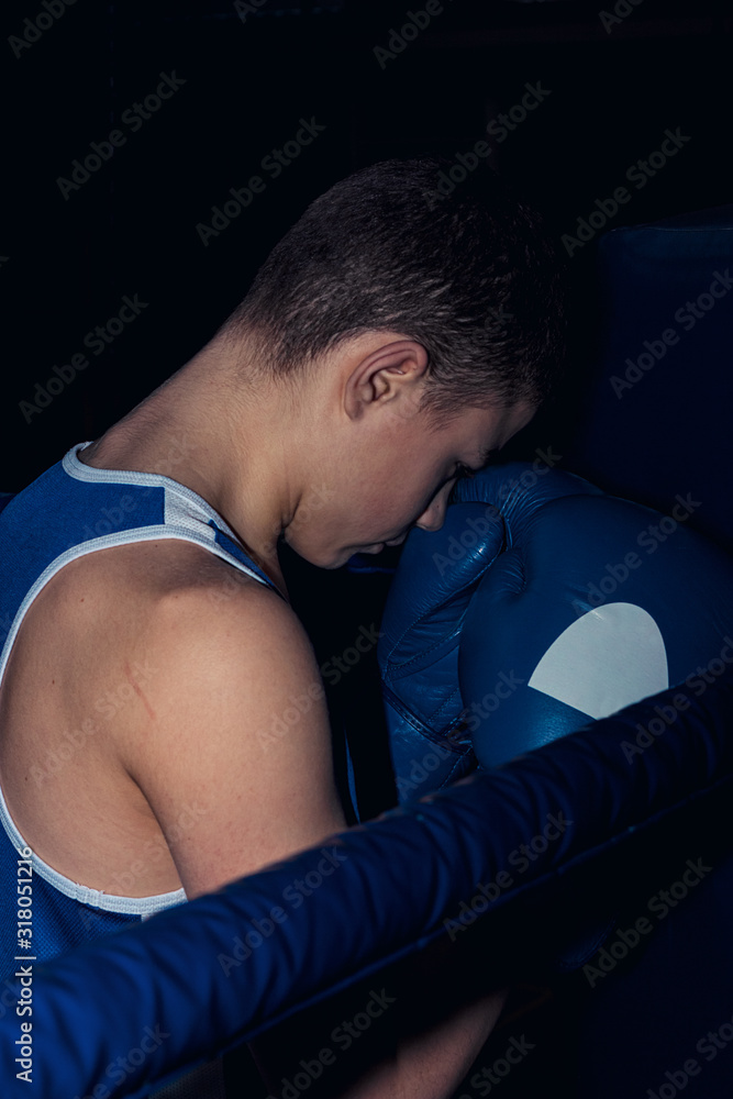 teen boxer in the corner of the ring teen boxer in the corner of the ring