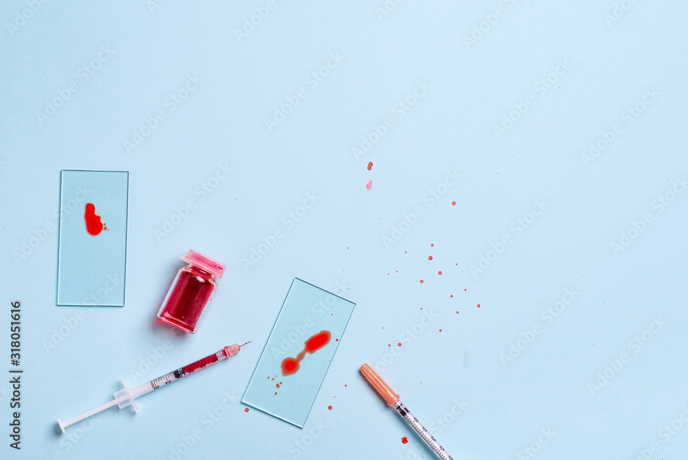 Test tubes with blood in laboratory on blue background Test tubes with blood in laboratory on blue background