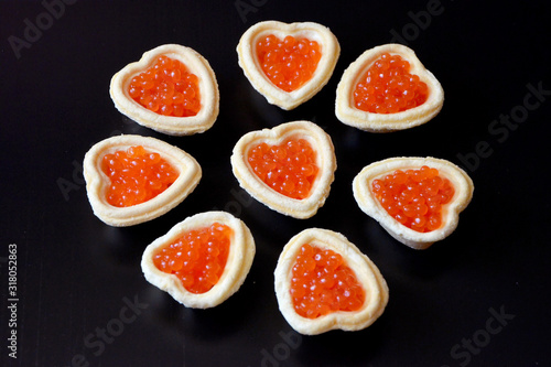 tartlets with red caviar  on a black background