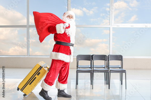 Santa Claus with luggage at...