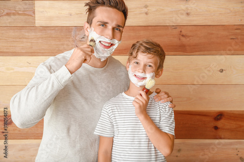 Father and son shaving toge...