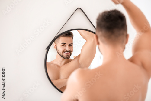 Handsome young man using de...