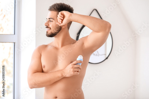 Handsome young man using de...