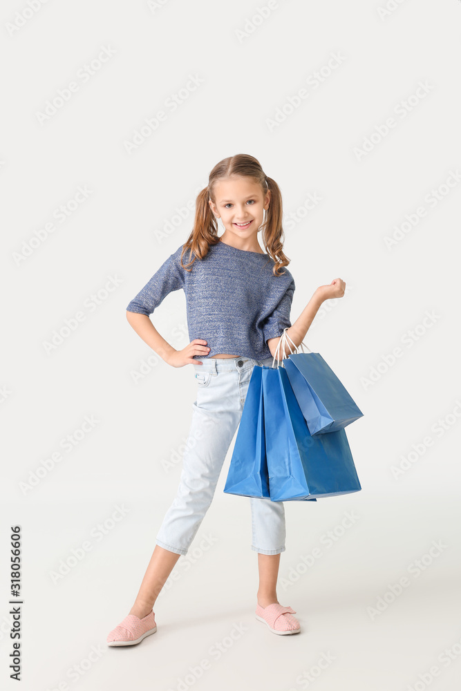 Cute little girl with shopping bags on white background Cute little girl with shopping bags on white background