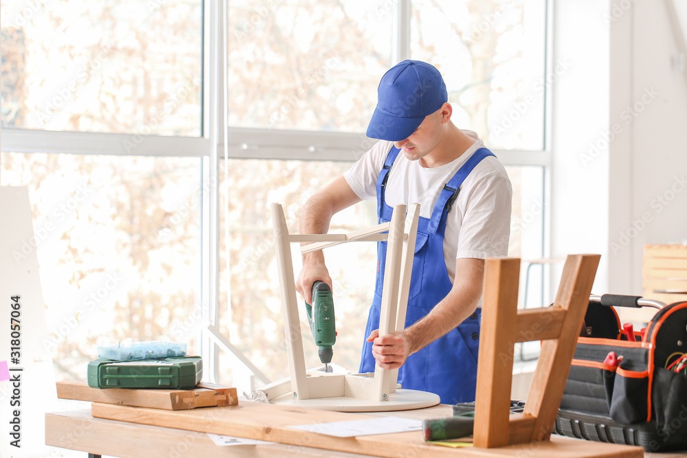 Handyman assembling furniture in workshop Handyman assembling furniture in workshop