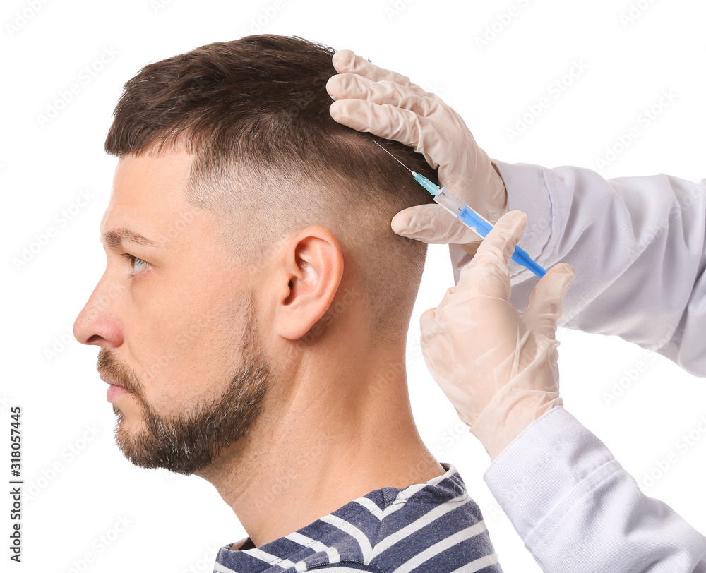 Man with hair loss problem receiving injection on white background Man with hair loss problem receiving injection on white background