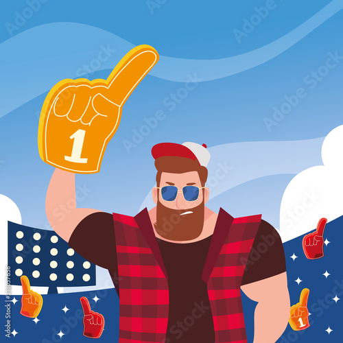 man holding a hand glove with number 1 fan, yellow foam finger in stadium