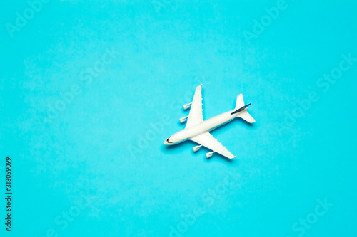 Travel minimal background. Model airplane in flight on an empty colored background. Copy space © uladzimirzuyeu