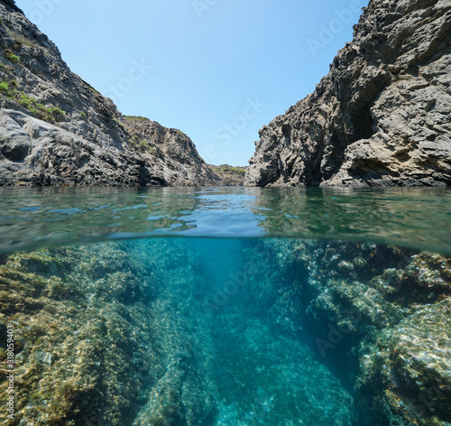 Mediterranean sea rocky coast with a passage between rocks, split view over and under water surface, Spain, Costa Brava, Catalonia, Cap de Creus