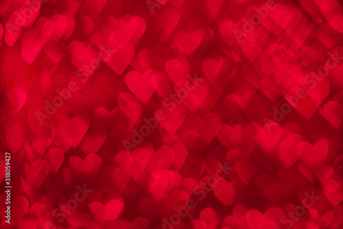 Valentine's day abstract background. Red gradient background with heart shaped bokeh effect. Valentines day, love, holiday concept. 