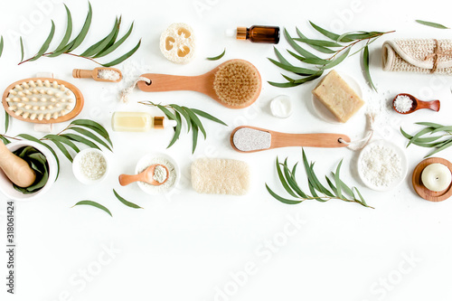 Spa concept with eucalyptus oil and eucalyptus leaf extract natural /organic spa cosmetics products, eco friendly bathroom accessories. Skincare concept on white background. Flat lay composition top v