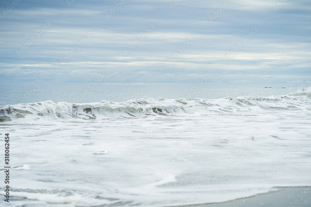 White Rolling Wave on Overcast Day in Malibu California White Rolling Wave on Overcast Day in Malibu California