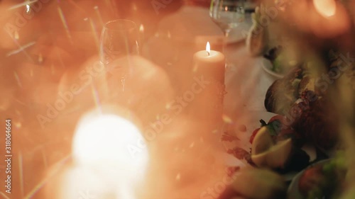 Table with a burning candle close-up. Beautiful light from the candles. Lyrically. photo