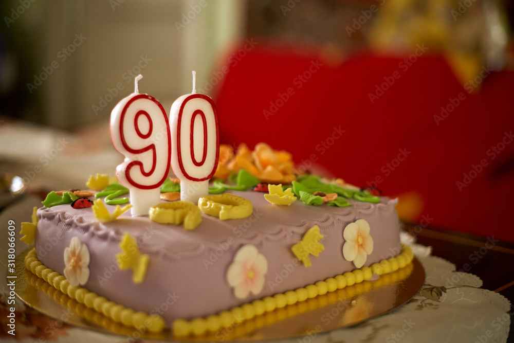 90th birthday cake with numbered candles. Stock Photo | Adobe Stock