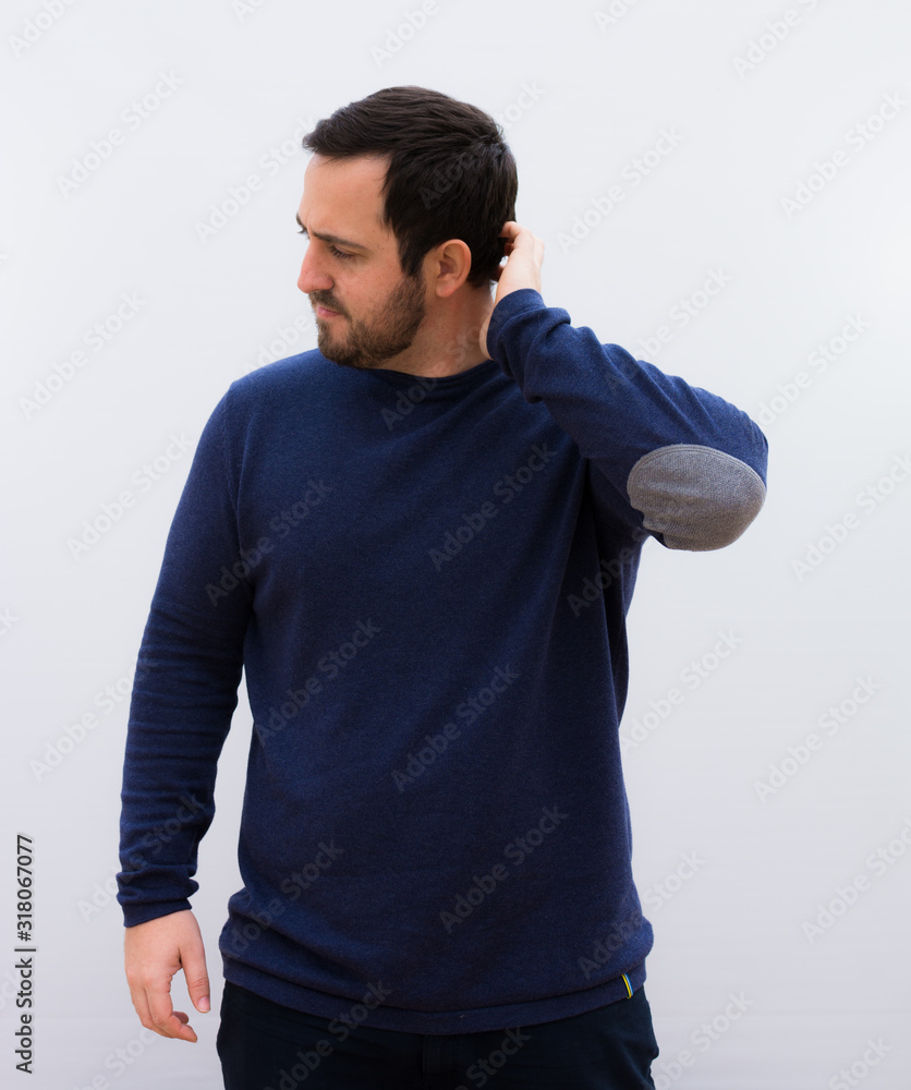 young handsome man feeling puzzled and confused, scratching head and looking to the side agains. young handsome man feeling puzzled and confused, scratching head and looking to the side agains.