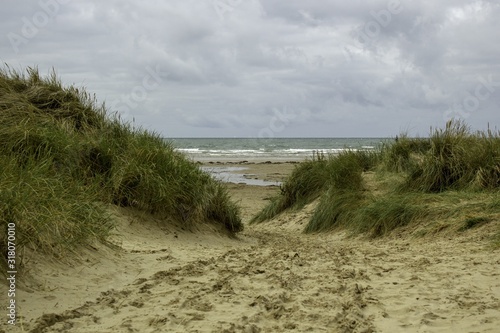 Beautiful shot of the Black Rock Sands Beach on a cloudy sky in  Porthmadog, Wales photo