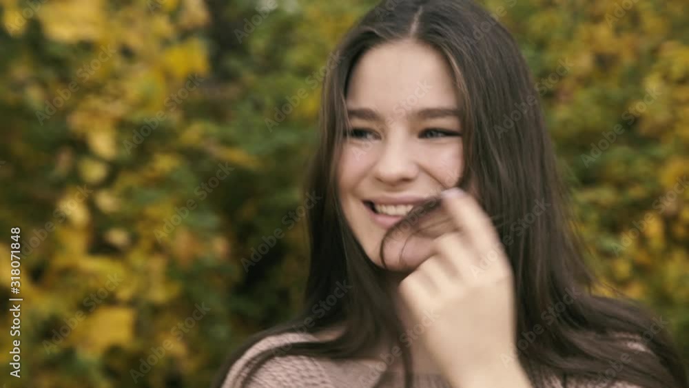 Portrait of absolutely happy girl with long hair and cute smile in park Portrait of absolutely happy girl with long hair and cute smile in park