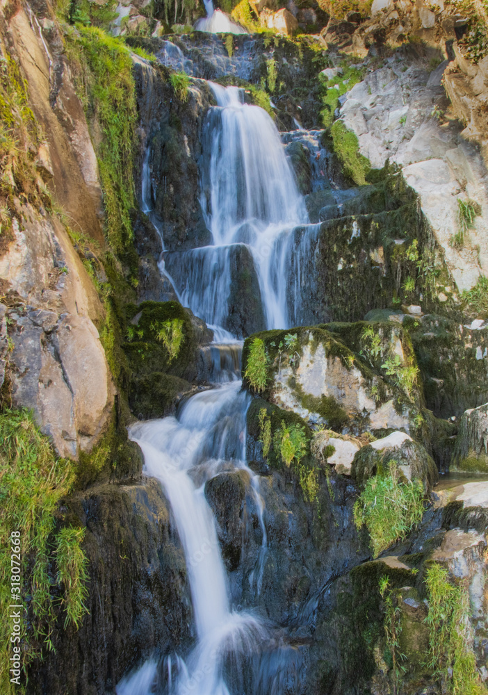 Obraz premium Waterfall cascades near St Beatus Swiss Caves (Thunersee)