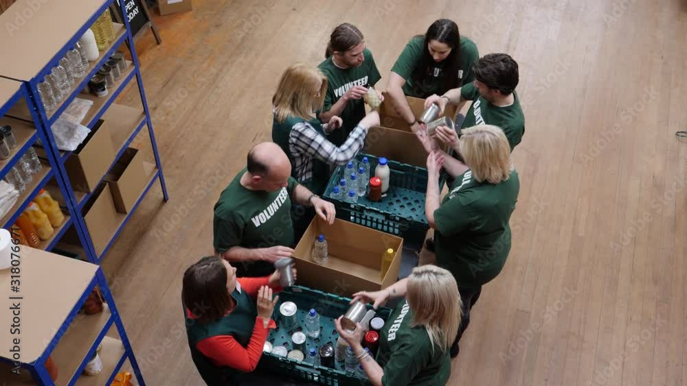 Food Bank volunteers help to sort food for hungry people and with social issues. Aerial View. Looking down from above,