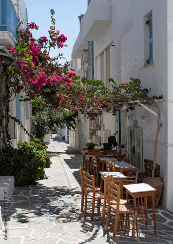 View of a small taverna, set in a shaded alley on the Greek island of Paros.  Picture taken at the small fishing village of Piso Livadi.  © John