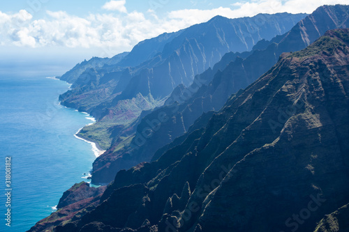 Aerial view of Kauai's lush colorful Na pali coast landscape. Dramatic volcanic basalt cliffs plunge into the Pacific. photo