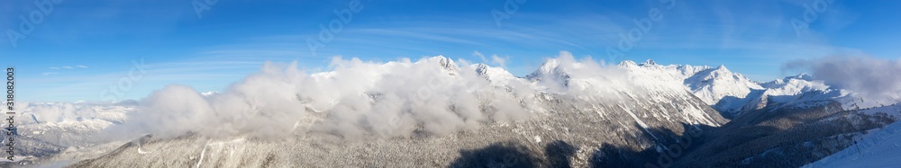 Whistler, British Columbia, Canada. Beautiful View of the Canadian Snow Covered Landscape with Blackcomb Mountain in Background during a cloudy and sunny winter day. Whistler, British Columbia, Canada. Beautiful View of the Canadian Snow Covered Landscape with Blackcomb Mountain in Background during a cloudy and sunny winter day.