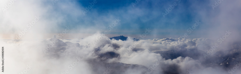 Aerial Panoramic View of the Beautiful Canadian Nature Mountain Landscape during a cloudy and sunny winter day. Taken from the Peak of Whistler, British Columbia, Canada.