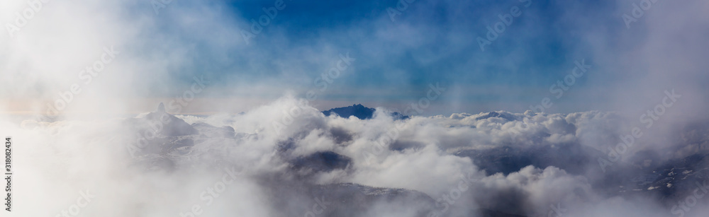 Aerial Panoramic View of the Beautiful Canadian Nature Mountain Landscape during a cloudy and sunny winter day. Taken from the Peak of Whistler, British Columbia, Canada. Aerial Panoramic View of the Beautiful Canadian Nature Mountain Landscape during a cloudy and sunny winter day. Taken from the Peak of Whistler, British Columbia, Canada.