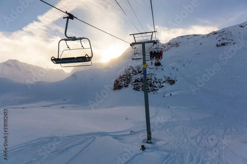 Whistler Ski Resort, British Columbia, Canada. Beautiful View of the snowy Canadian Nature Landscape Mountain and Chairlift going to the peak during a vibrant winter morning.
