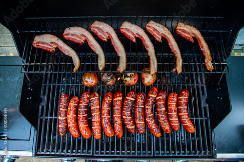 Sausages, Bacon and Potatoes on BBQ photo