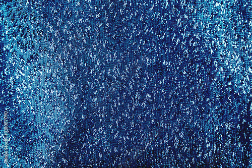 Blue shiny glitter textured textile background with glow