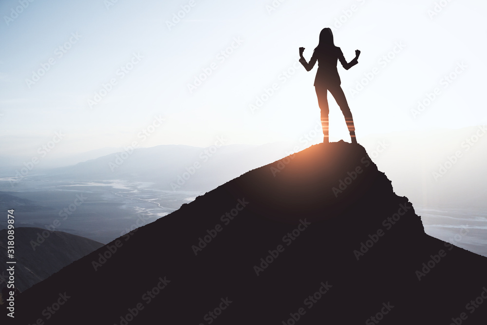 Happy businesswoman on cliff