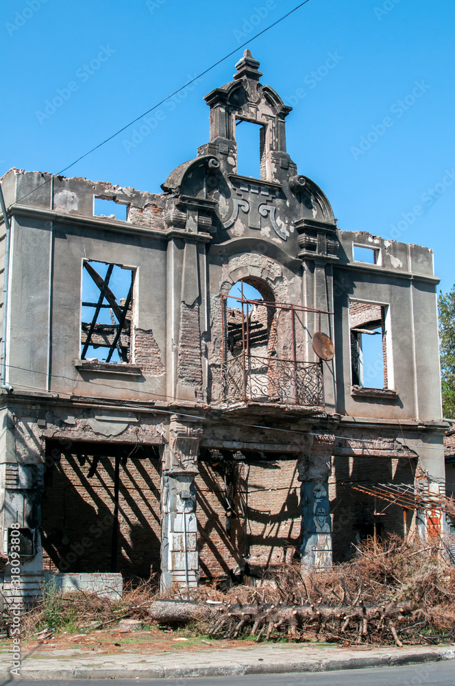 Old burnt and destroyed countryside house closeup in clear sunny day