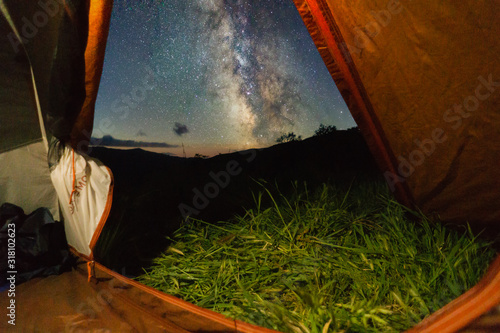 Milky way outside a tent at twilight photo