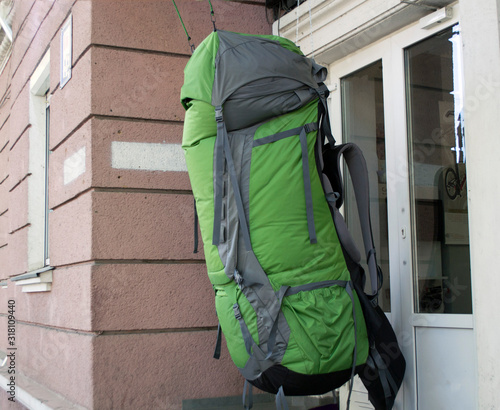 giant green backpack hanging in front of the door